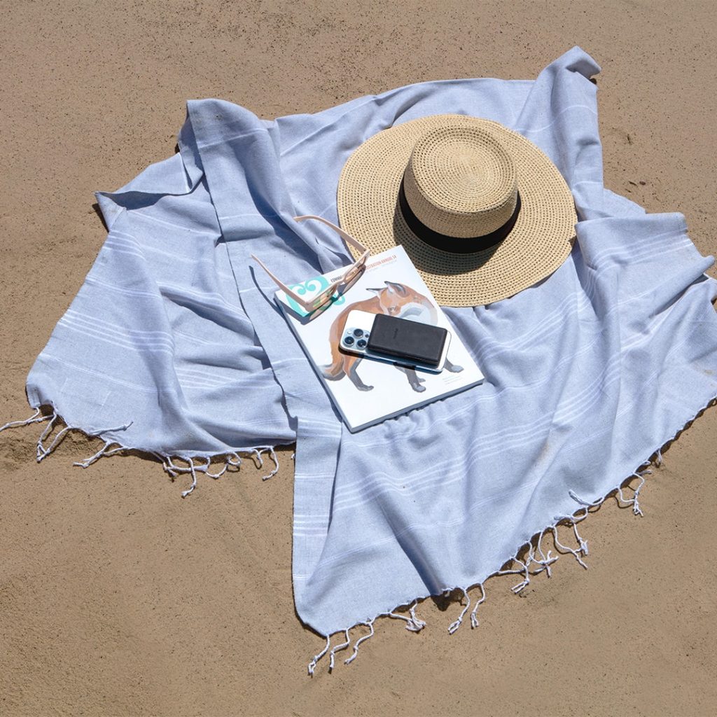 iphone laying on beach blanket on the beach