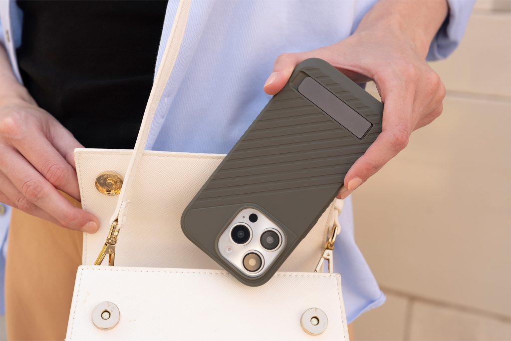 woman putting iphone 16 pro into her purse