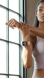 fitness woman stretching with apple watch 