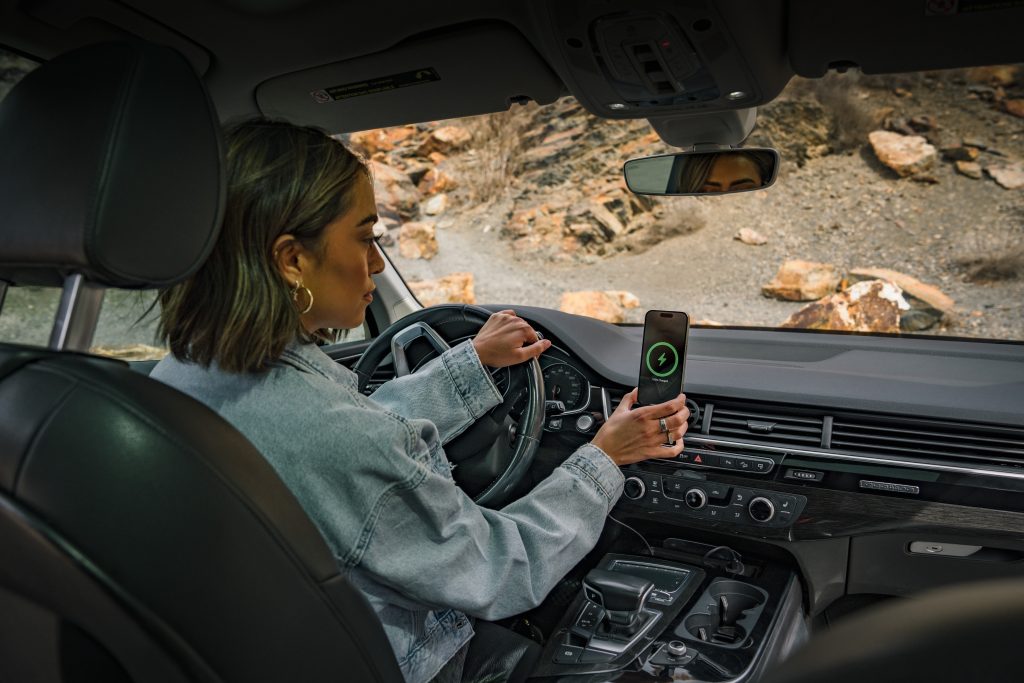 sports mom in car using car mount for phone