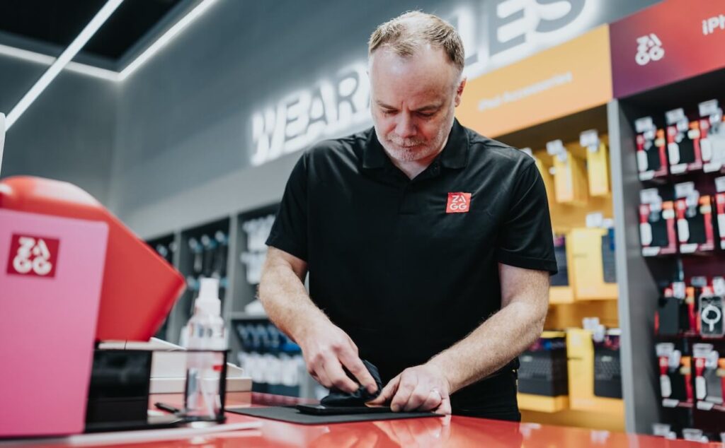 Professional installing a screen protector on a phone